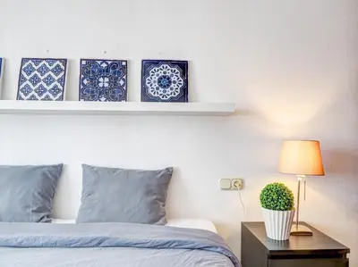 a bedroom with blue and white plates on a wall at Llopart Apartment by Hello Homes Sitges in Sitges