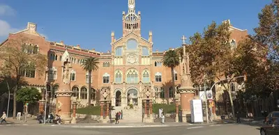 a large brick building with a clock tower on it at Hotel Continental Palacete in Barcelona