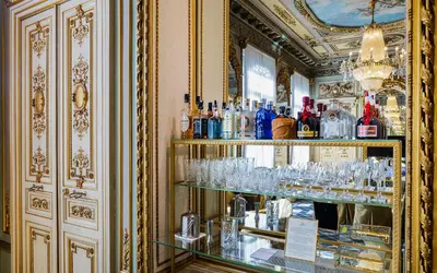 a bar with glasses on shelves in a room at Hotel Continental Palacete in Barcelona