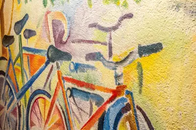a painting of bikes parked next to a wall at Apartaments Ciutat Vella in Barcelona