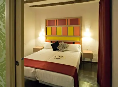 a bedroom with a large bed with a colorful headboard at Apartaments Ciutat Vella in Barcelona
