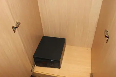 a black appliance sitting on a wooden shelf in a door at Apartaments Ciutat Vella in Barcelona