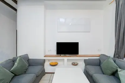 a living room with a couch and a flat screen tv at Canela Homes BARCELONA GÒTIC in Barcelona