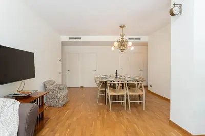 a living room with a dining room table with chairs at Canela Homes BARCELONA ICÀRIA in Barcelona