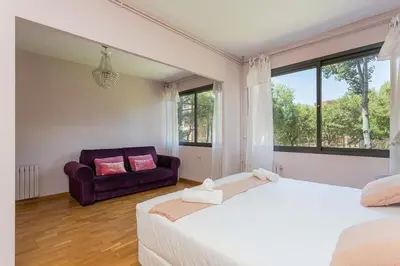 a bedroom with two beds and a couch at Canela Homes BARCELONA ICÀRIA in Barcelona