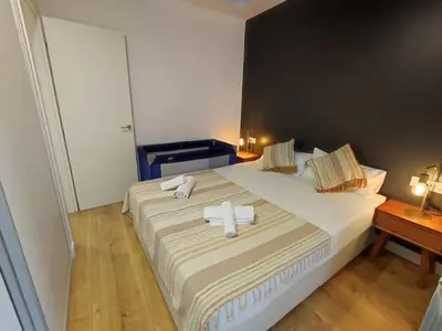 a bedroom with a large bed with towels on it at Canela Homes BARCELONA STYLE in Barcelona