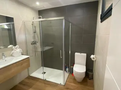 a bathroom with a shower with a toilet and a sink at Matarolux26 in Mataró