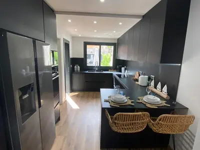 a kitchen with black cabinets and a black counter at Matarolux26 in Mataró