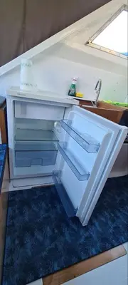 an empty refrigerator with its door open in a room at COSY BOAT FLAT at BARCELONA BEACH in Barcelona