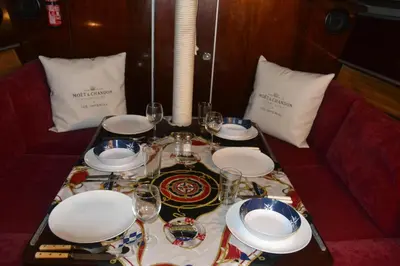 a table with plates and wine glasses on it at COSY BOAT FLAT at BARCELONA BEACH in Barcelona