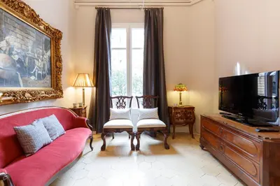 a living room with a red couch and a flat screen tv at AinB B&B Born-Via Laietana in Barcelona