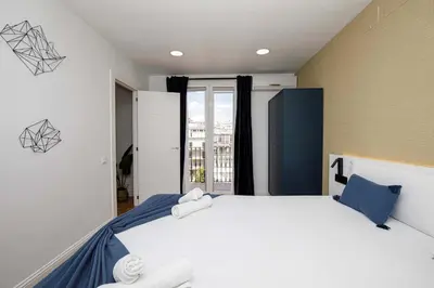 a bedroom with a large bed with two towels on it at Stay U-nique Apartments Rambla Catalunya VI in Barcelona