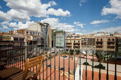 a bench sitting on a balcony overlooking a city at Stay U-nique Apartments Rambla Catalunya VI in Barcelona