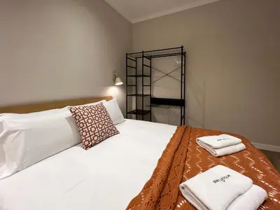 a bedroom with a white bed with towels on it at Stay U-nique Apartment Muntaner in Barcelona