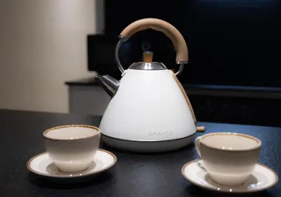 a tea kettle and two cups on a counter at Stay U-nique Apartment Muntaner in Barcelona