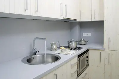 a kitchen with a sink and white cabinets at ClassBedroom Barcelona Beach Apartments in Barcelona