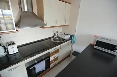 a small kitchen with a sink and a stove at Apartamento Sunny Home in Cunit