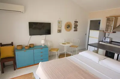 a bedroom with a bed and a tv and a table at Apartamento Sunny Home in Cunit