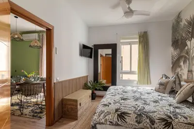 a bedroom with a bed and a desk in a room at OASIS BEACH-CITY apartment in Montgat