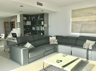 a living room with a couch and a coffee table at Sitges espectacular vista al mar in Sant Pere de Ribes