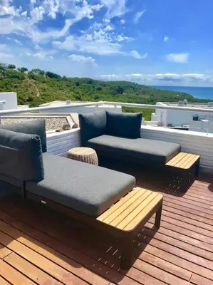 a patio with two couches and two chairs on a deck at Sitges espectacular vista al mar in Sant Pere de Ribes