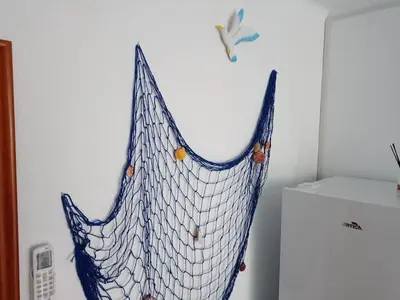 a net hanging on a wall in a room at GARDEN'S SEA PiNEDA DE MAR in Pineda de Mar