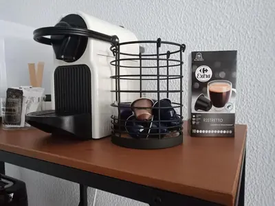 a table with a coffee maker and a basket on it at GARDEN'S SEA PiNEDA DE MAR in Pineda de Mar