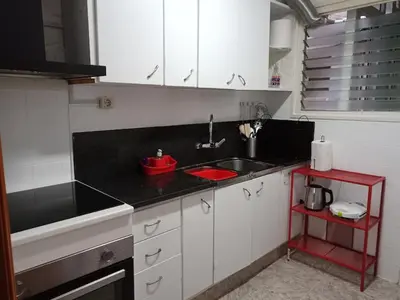 a kitchen with a sink and a red bowl on the counter at GARDEN'S SEA PiNEDA DE MAR in Pineda de Mar