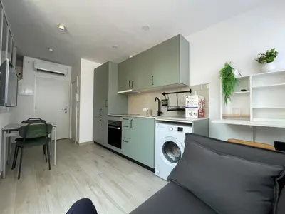 a kitchen with a washing machine in a living room at Baetulo III in Badalona