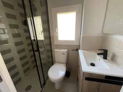 a bathroom with a toilet and a shower and a sink at Baetulo III in Badalona
