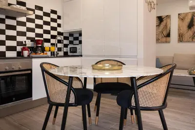 a kitchen with a table and two chairs at Charming Seaside Apartment in Barceloneta, Renovated with Stunning Sea Views in Barcelona
