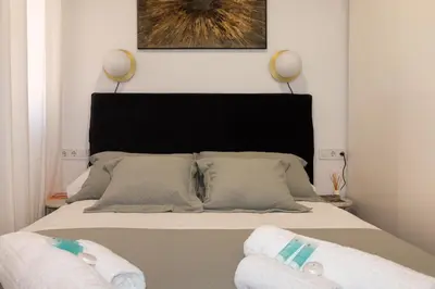 a bedroom with a bed with two towels on it at Charming Seaside Apartment in Barceloneta, Renovated with Stunning Sea Views in Barcelona