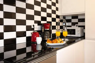 a kitchen counter with a plate of oranges and juice at Charming Seaside Apartment in Barceloneta, Renovated with Stunning Sea Views in Barcelona