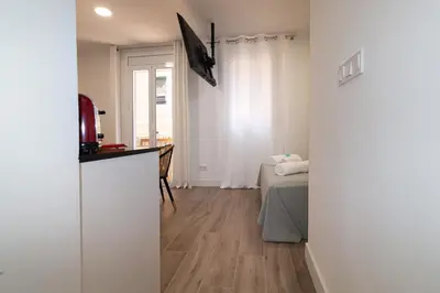 a room with a bedroom with a bed and a window at Charming Seaside Apartment in Barceloneta, Renovated with Stunning Sea Views in Barcelona