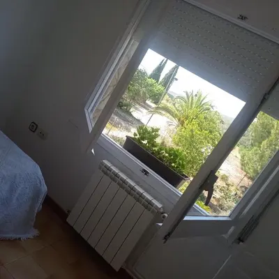 a room with a window with a radiator at Ca La Montserrat - Wine Rural House in San Martín Sarroca