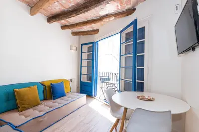 a living room with a couch and a table at Apartamentos Mayor by Habama Group in Sitges