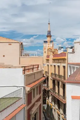 a view from the roof of a building with a clock tower at Apartamentos Mayor by Habama Group in Sitges