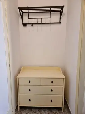 a bedroom with a dresser and a shelf on the wall at Apartment in Downtown 2 bedrooms AC 30 nigths min in Barcelona