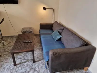 a living room with a couch and a table at Apartment in Downtown 2 bedrooms AC 30 nigths min in Barcelona