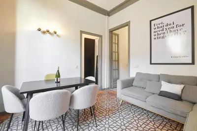 a living room with a couch and a table and chairs at 