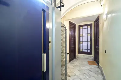 a hallway with blue walls and a door with a window at 