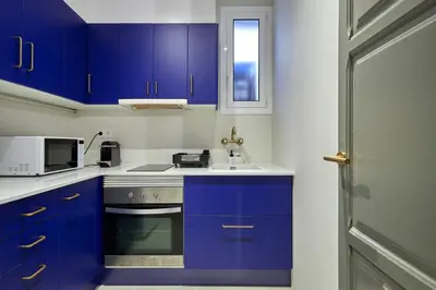 a kitchen with blue cabinets and a sink at 