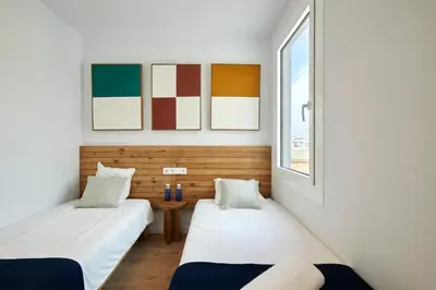 two beds in a room with a window at 