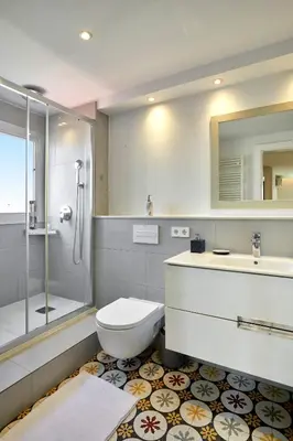 a bathroom with a toilet and a sink and a shower at 