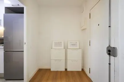 two refrigerators in a white room with a refrigerator at 