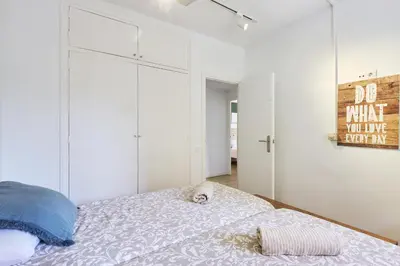 a bedroom with white cabinets and a bed at 