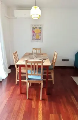 a dining room table with four chairs and a light at Opening Doors Premiá Beach - Sol & playa cerca Barcelona in Premiá de Mar