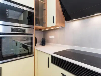 a kitchen with a stove and a microwave at Sitges Spaces Seaside Paradise in Sitges