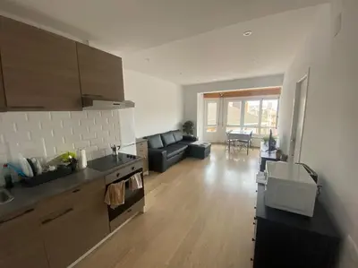 a kitchen and living room with a couch and a table at Habitacion en piso de 3 habitaciones, Manresa Near train Barcelona 2 in Manresa
