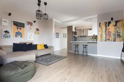a living room with a couch and a kitchen at Fantastic view penthouse apartment in Barcelona
